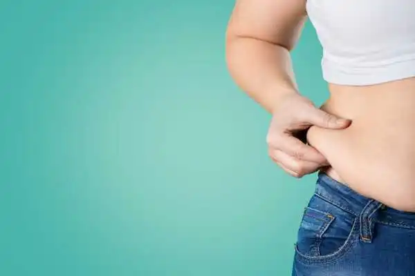 Image of woman pinching her love handles to show weight gain Chester