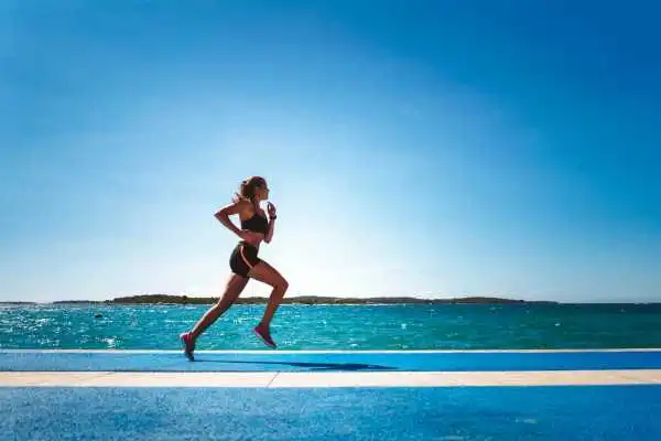 Woman running showing strong leg muscle Chester